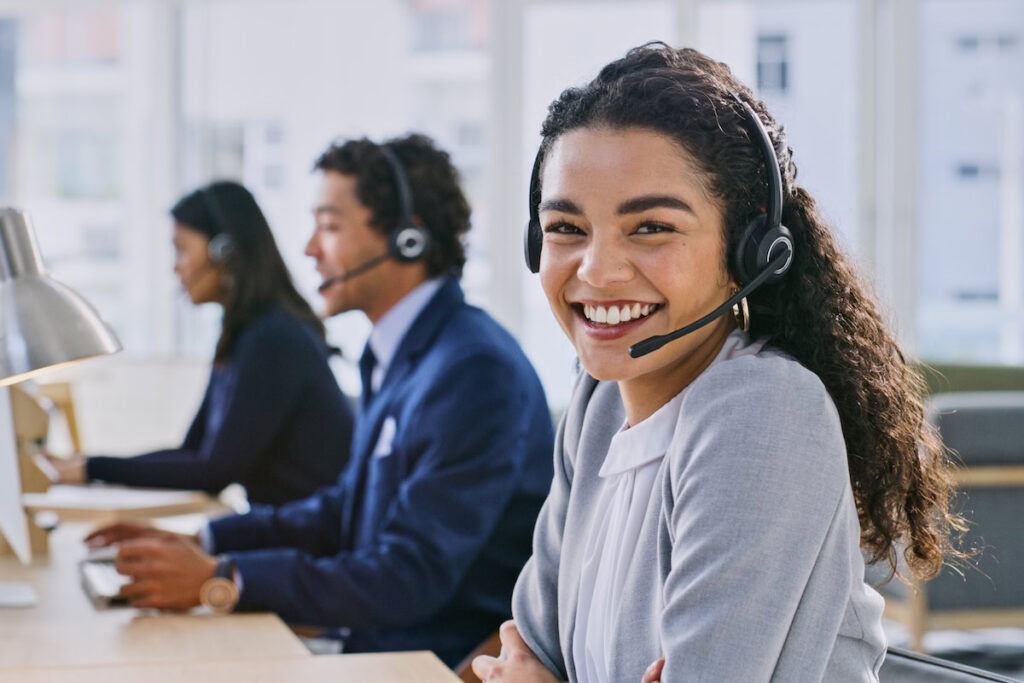 The Future of Work in 2026: How AI Is Reshaping Jobs, Skills, and Careers call center woman, smile and portrait at headphones, job and staff group with computer, advice and office. telemarketing agent, pc and microphone at help desk, consulting or listen for tech support