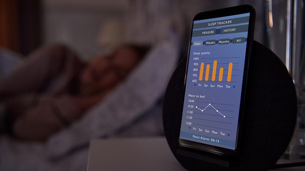 Shocking: 10 Things Your Smartphone Is Spying Secretly on You (Without You Knowing) Phone on nightstand tracking sleep patterns